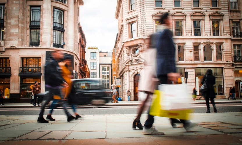 People walking fast with briefcases in a city street