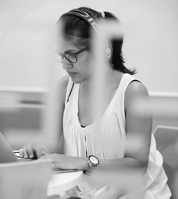 A member of the Equal Experts working at a laptop in an office.