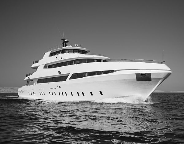 A luxury private motor yacht under way on tropical sea.