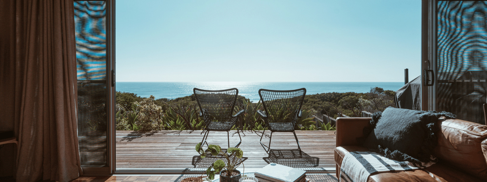 image of villa with two seats looking out into the ocean.