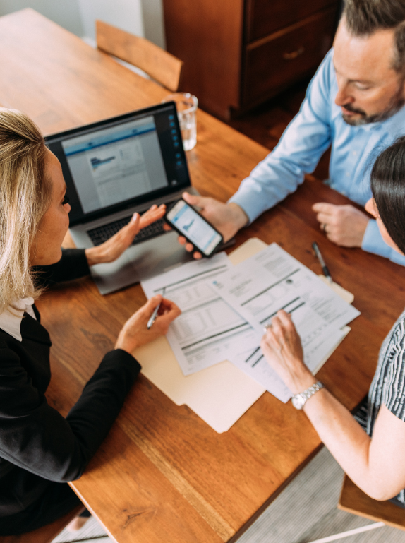 A couple meet with a financial advisor and use technology to plan their investments