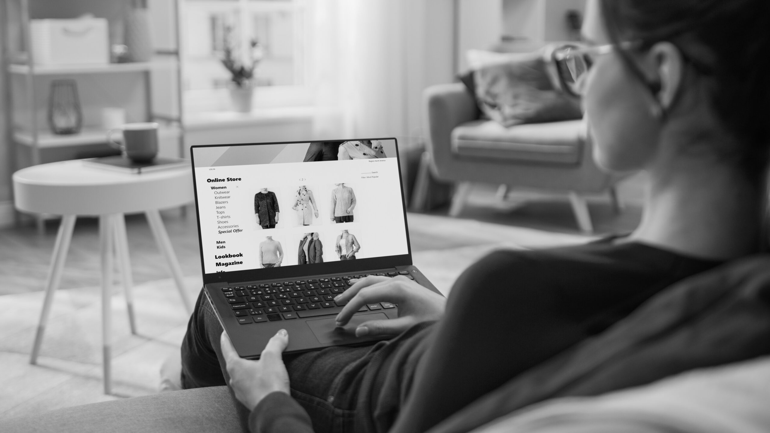 Woman browsing clothing online on a laptop at home.